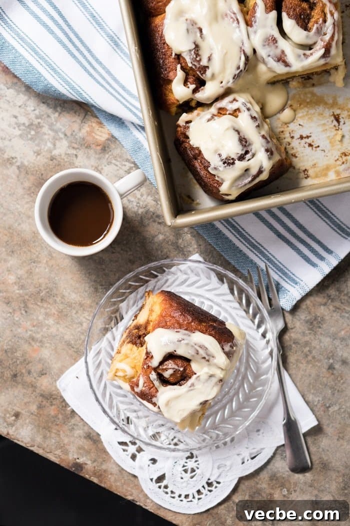Fluffy Paleo and Keto Cinnamon Rolls Recipe with Yeast 8 A keto cinnamon roll on a plate with coffee on the side