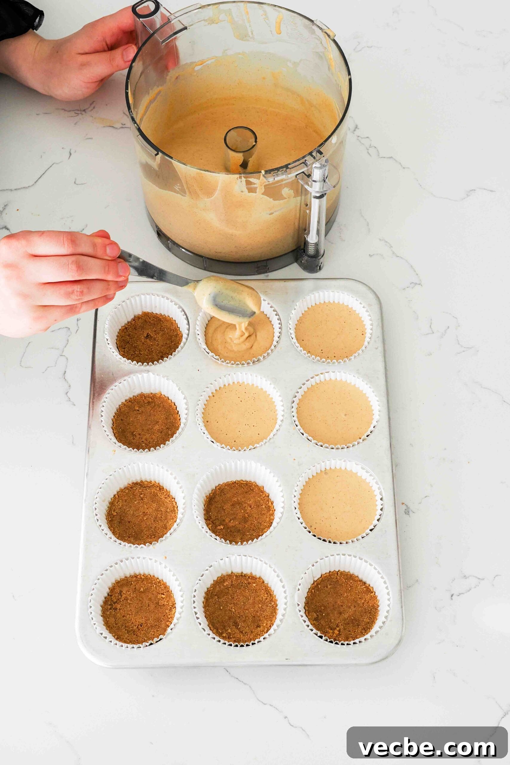 Mini Pecan Pie Cheesecake Bites Recipe 9 Brown sugar cinnamon cheesecake is added on top of graham cracker crusts in a lined muffin pan.