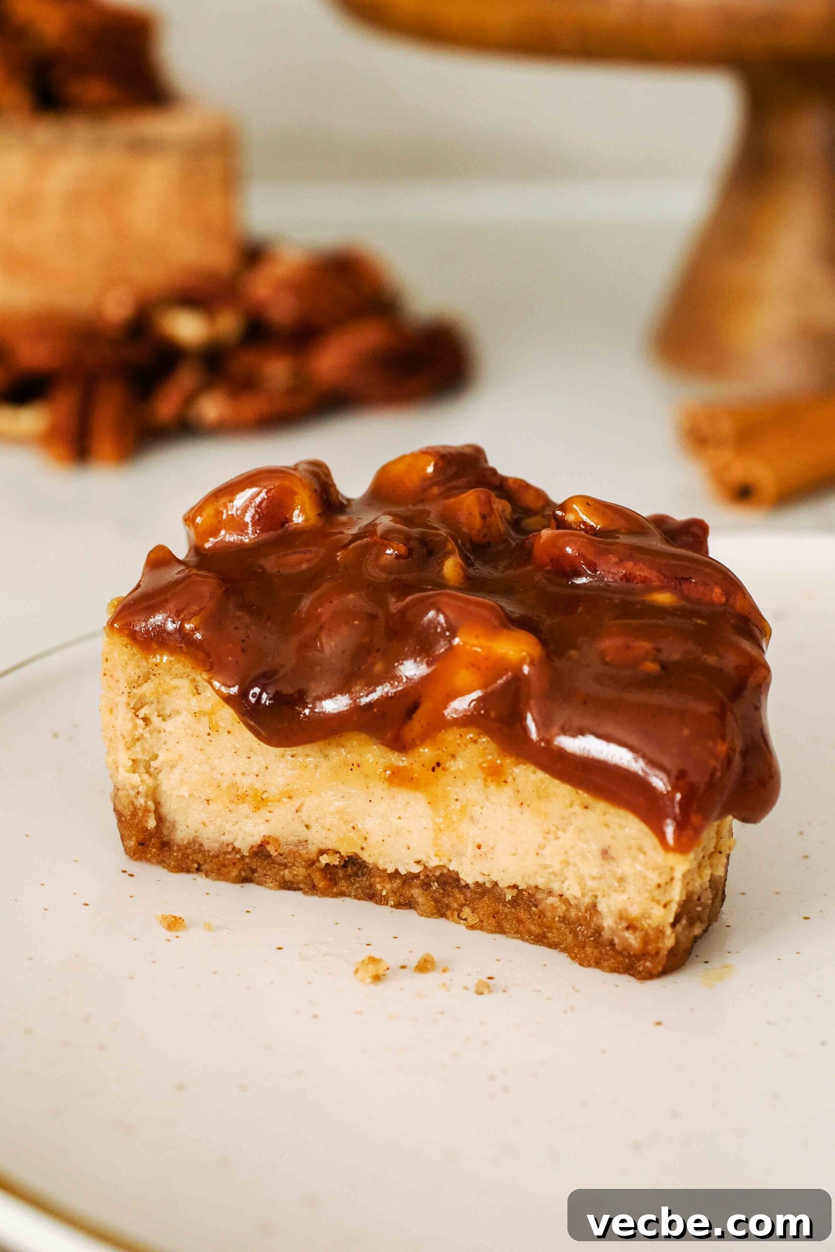 Mini Pecan Pie Cheesecake Bites Recipe 19 Half of a mini pecan pie cheesecake on a plate.