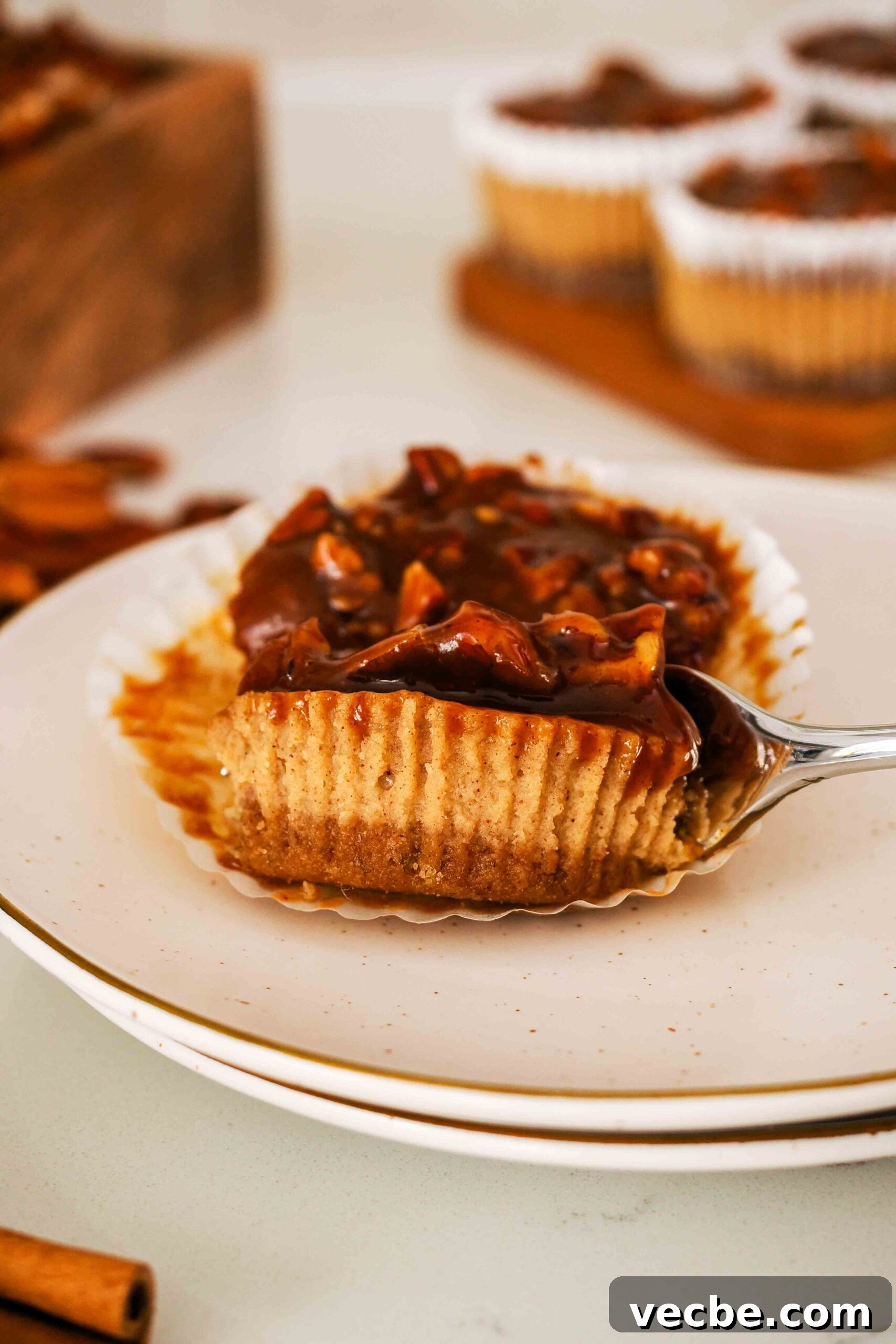 Mini Pecan Pie Cheesecake Bites Recipe 21 A fork cuts into a mini pecan pie cheesecake.
