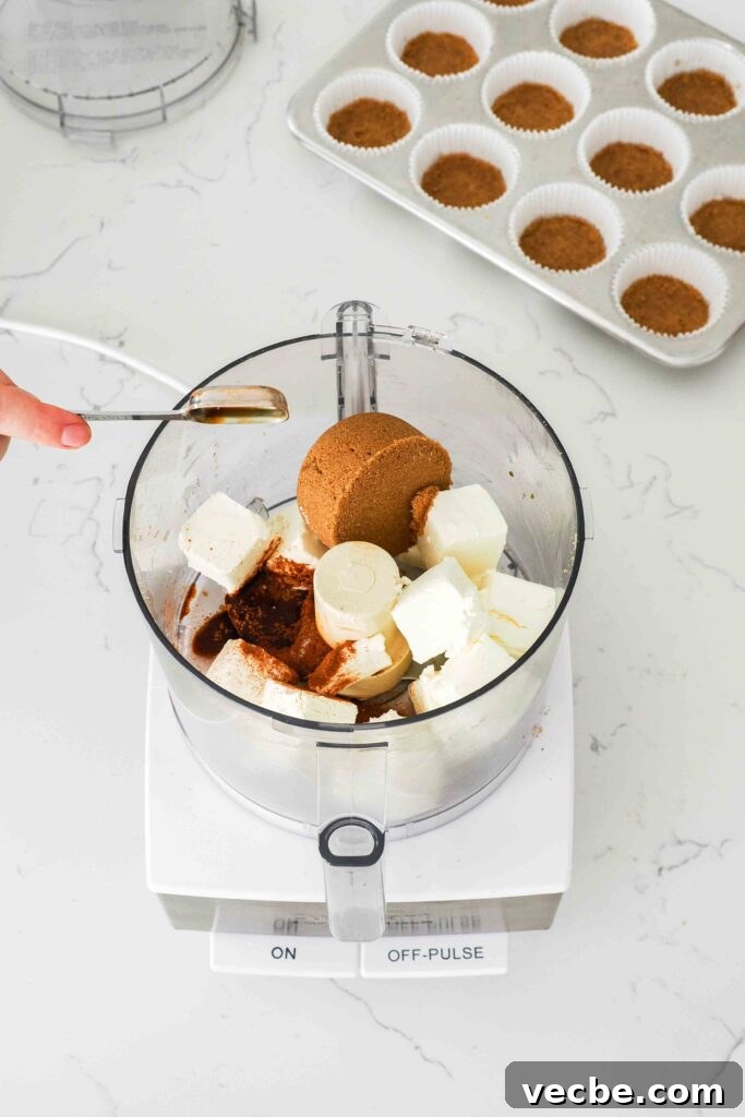 Mini Pecan Pie Cheesecake Bites Recipe 7 Cream cheese, brown sugar, vanilla, and cinnamon are added to a food processor bowl.