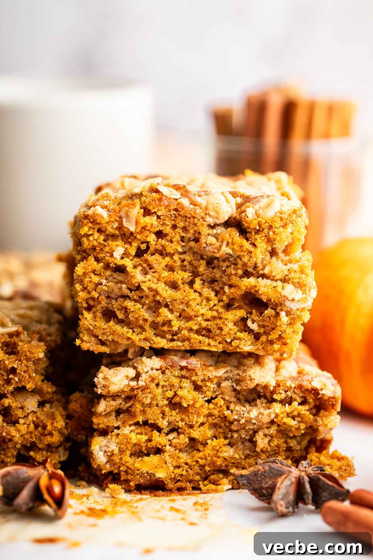 Pumpkin Coffee Cake Recipe with Cinnamon Streusel 7 Two square slices of orange pumpkin cake stacked on top of each other.