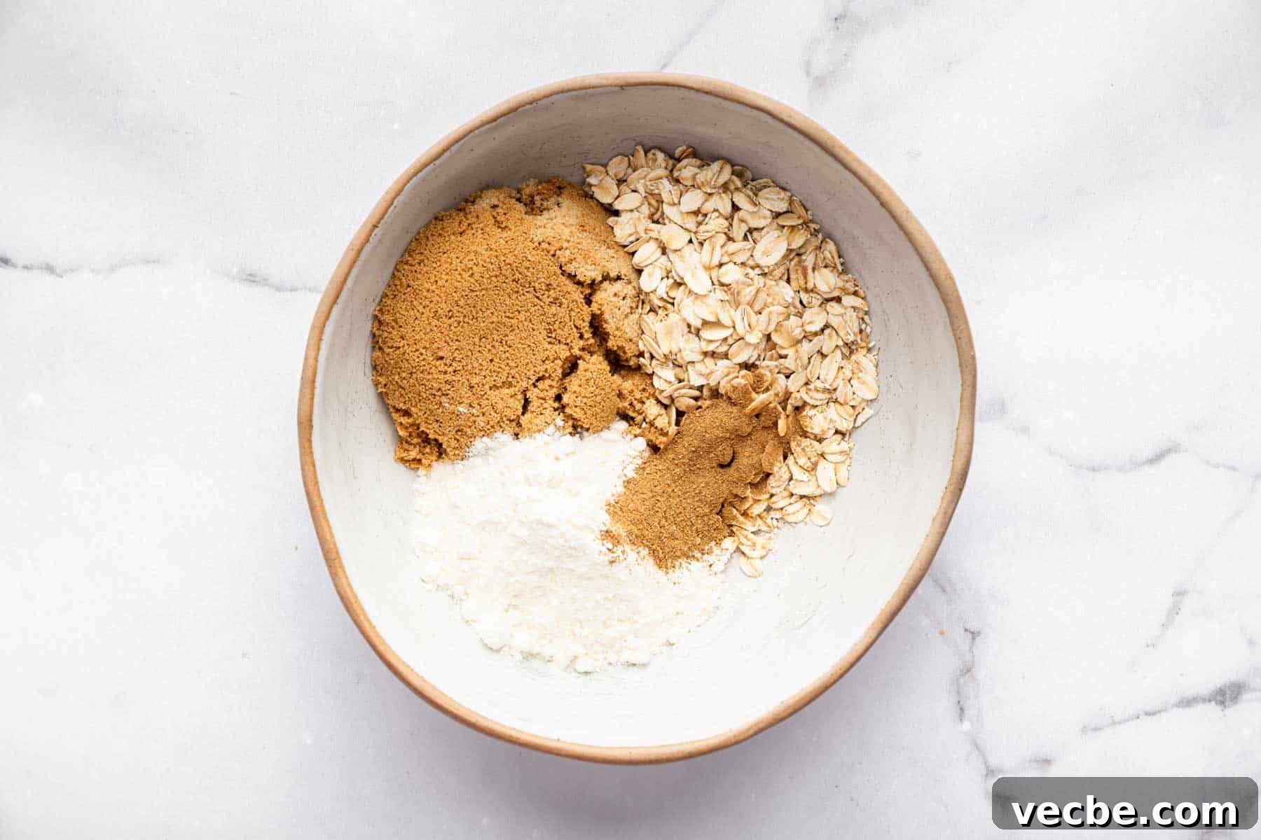 Pumpkin Coffee Cake Recipe with Cinnamon Streusel 4 White bowl with brown sugar, oats, flour, and spices.