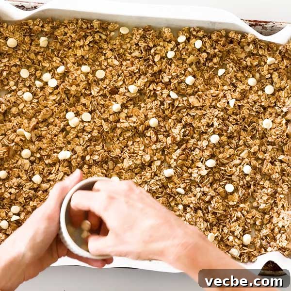 White Chocolate Vanilla Almond Granola 10 Sprinkling white chocolate chips over the vanilla granola before going into the oven.