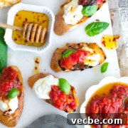 Tomato Confit & Burrata Crostini with a spicy sweet drizzle of chili honey