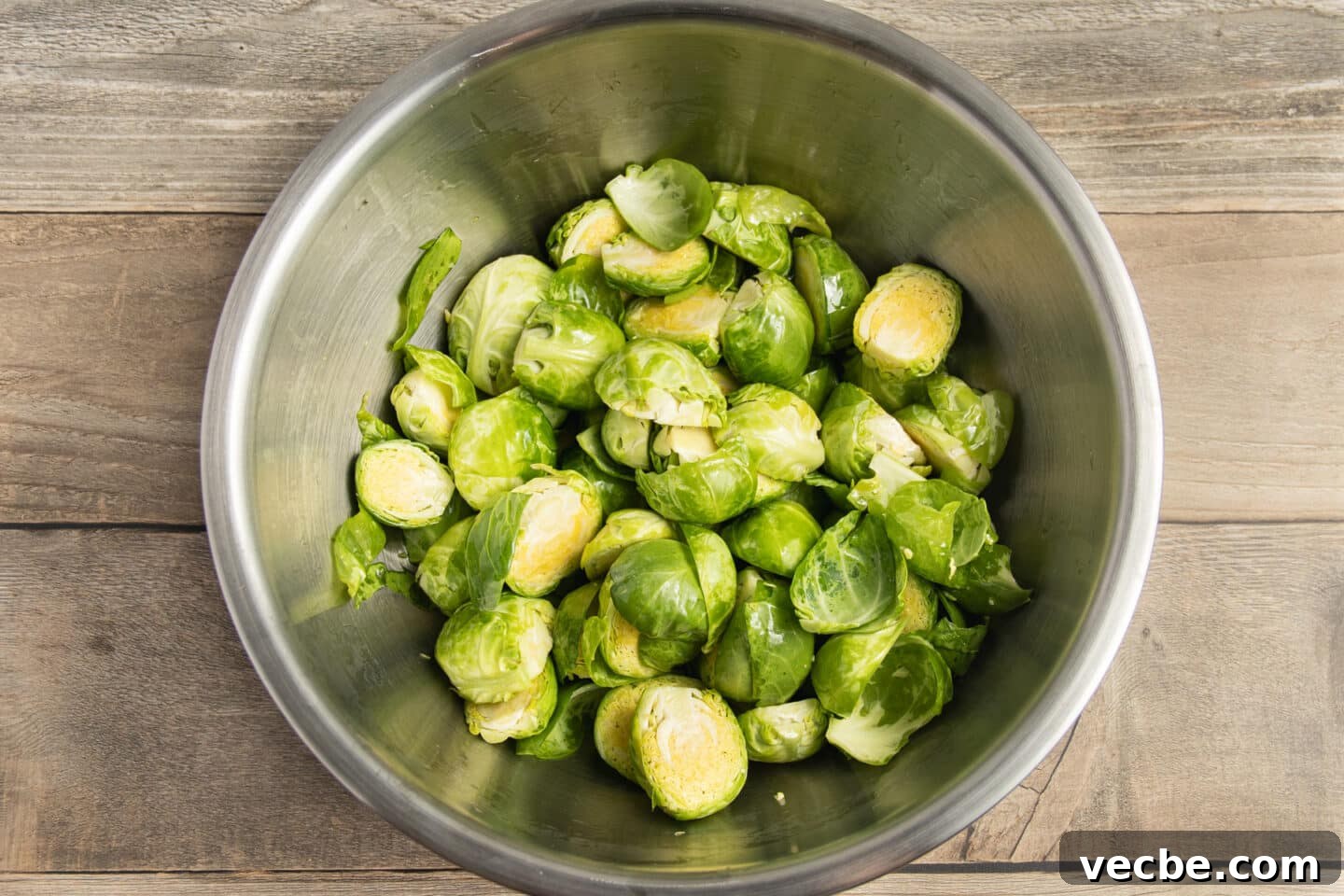 Crispy Oven-Roasted Brussels Sprouts with Feta 6 This is a picture of a bowl of Brussels sprouts seasoned with oil.