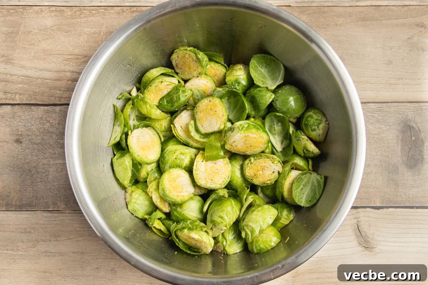 Crispy Oven-Roasted Brussels Sprouts with Feta 7 This is a picture of a bowl of Brussels sprouts seasoned with spices.