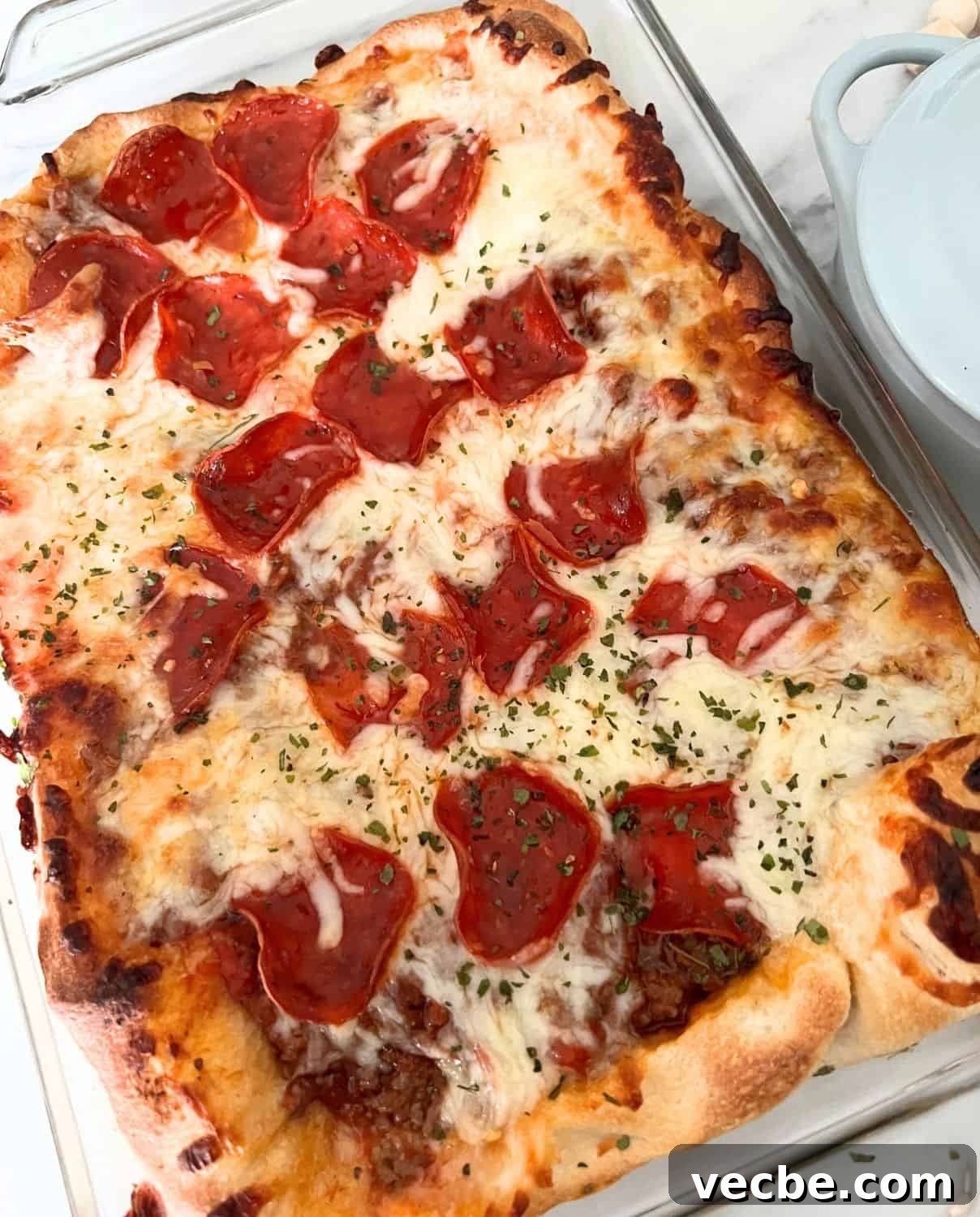Chicago-Style Deep-Dish Pizza Casserole Recipe 2 Finished deep dish pizza casserole in a clear casserole dish.