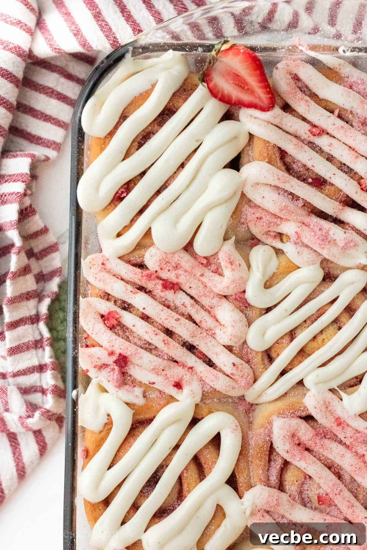 Strawberry Cheesecake Cinnamon Rolls Recipe 10 Baked strawberry cheesecake cinnamon rolls in glass pan.