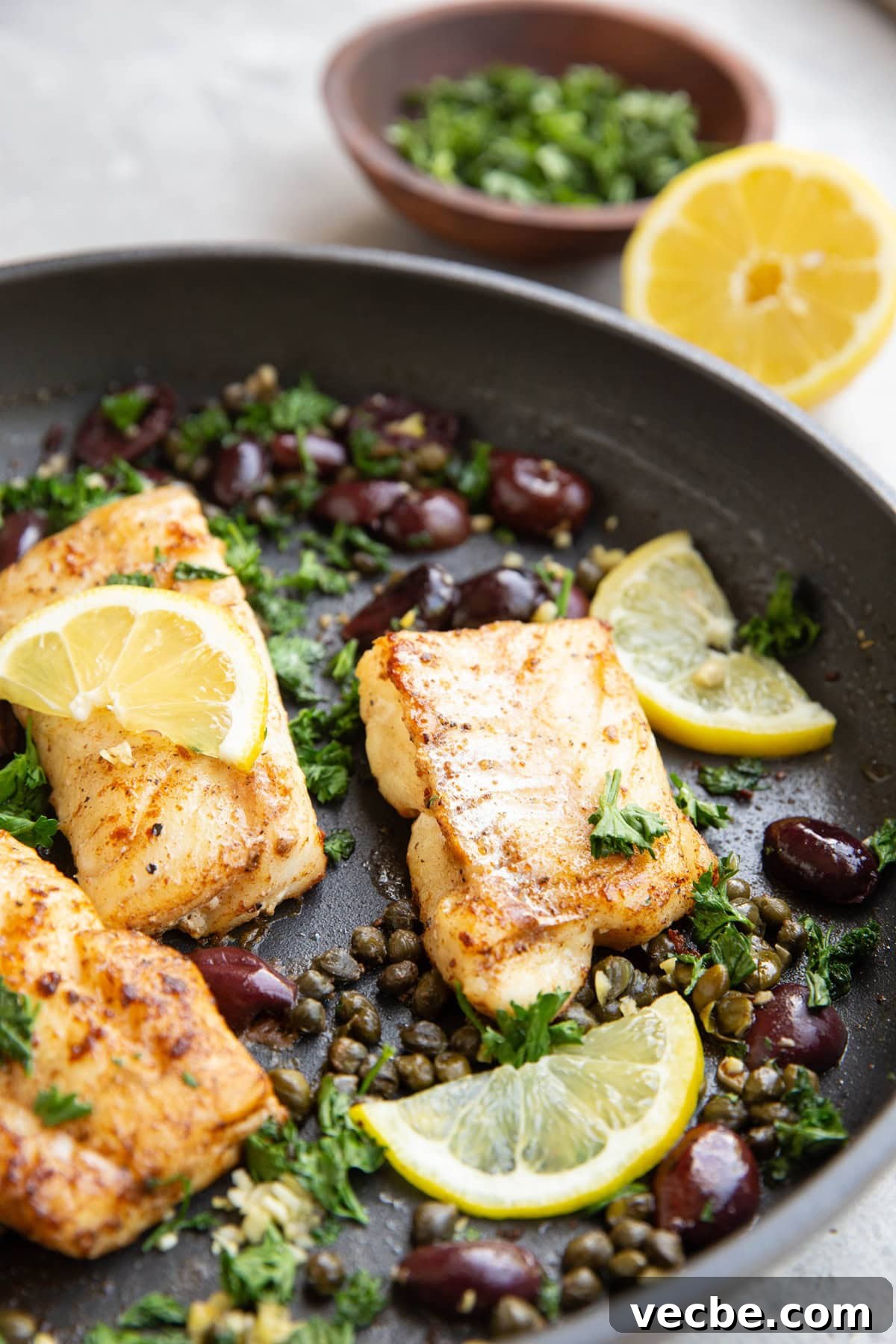 Pan-Fried Mediterranean Cod with Lemon, Olives and Tomatoes 3 Skillet of seared cod with olives, capers, and lemon.