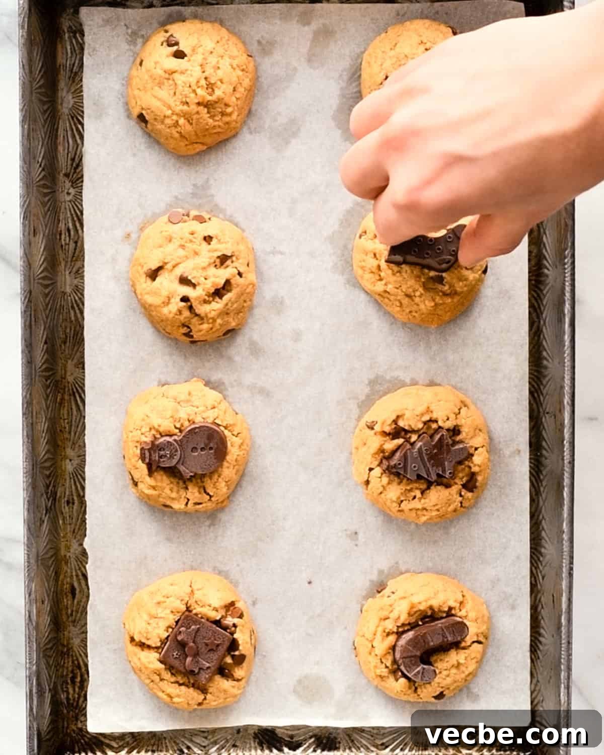 Gluten Free Peanut Butter Blossoms Recipe 10 placing frozen chocolate on baked cookies