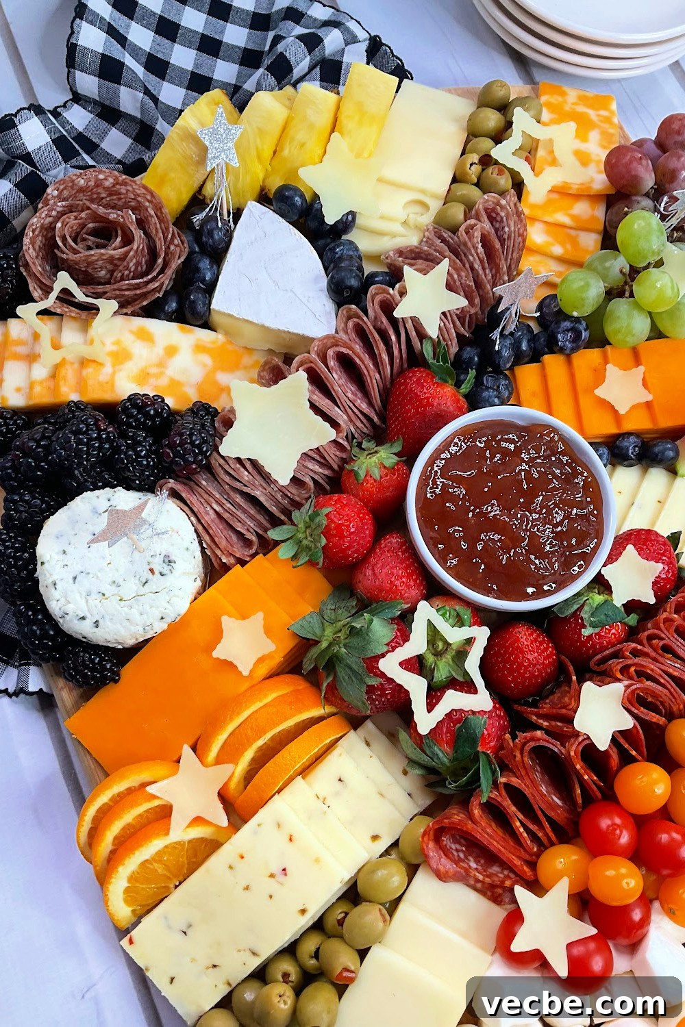 Graduation Charcuterie Board Ideas for Your Party 3 Close up of graduation party charcuterie board with the congrats made out of cheeses and jams and dips.