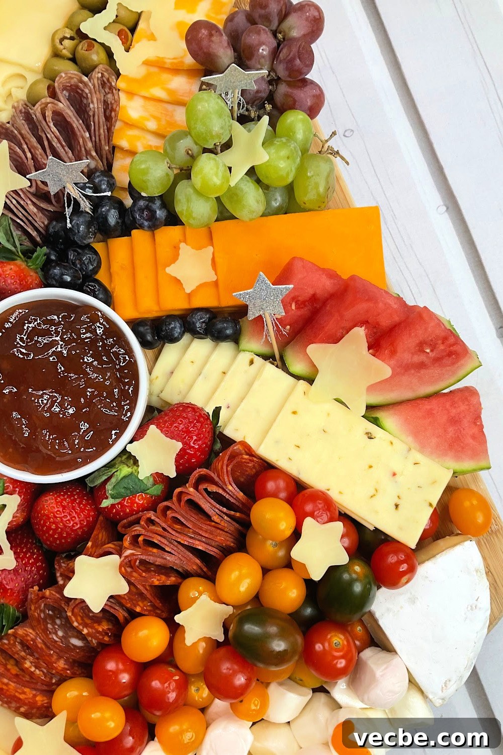 Graduation Charcuterie Board Ideas for Your Party 4 graduation party charcuterie board with the congrats made out of cheeses and watermelon, tomatoes and grapes..