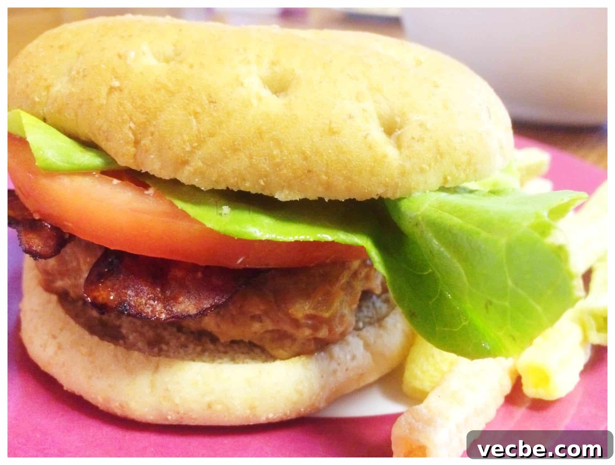 Weight Watchers Meal Plan: Week of June 19–25 4 Turkey burger with lettuce and tomato with french fries alongside on pink placemat.