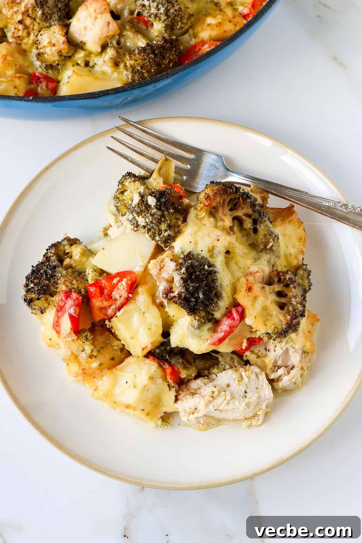 Creamy Baked Chicken, Broccoli and Potato Casserole 3 Side shot of the chicken casserole on a plate with a fork.