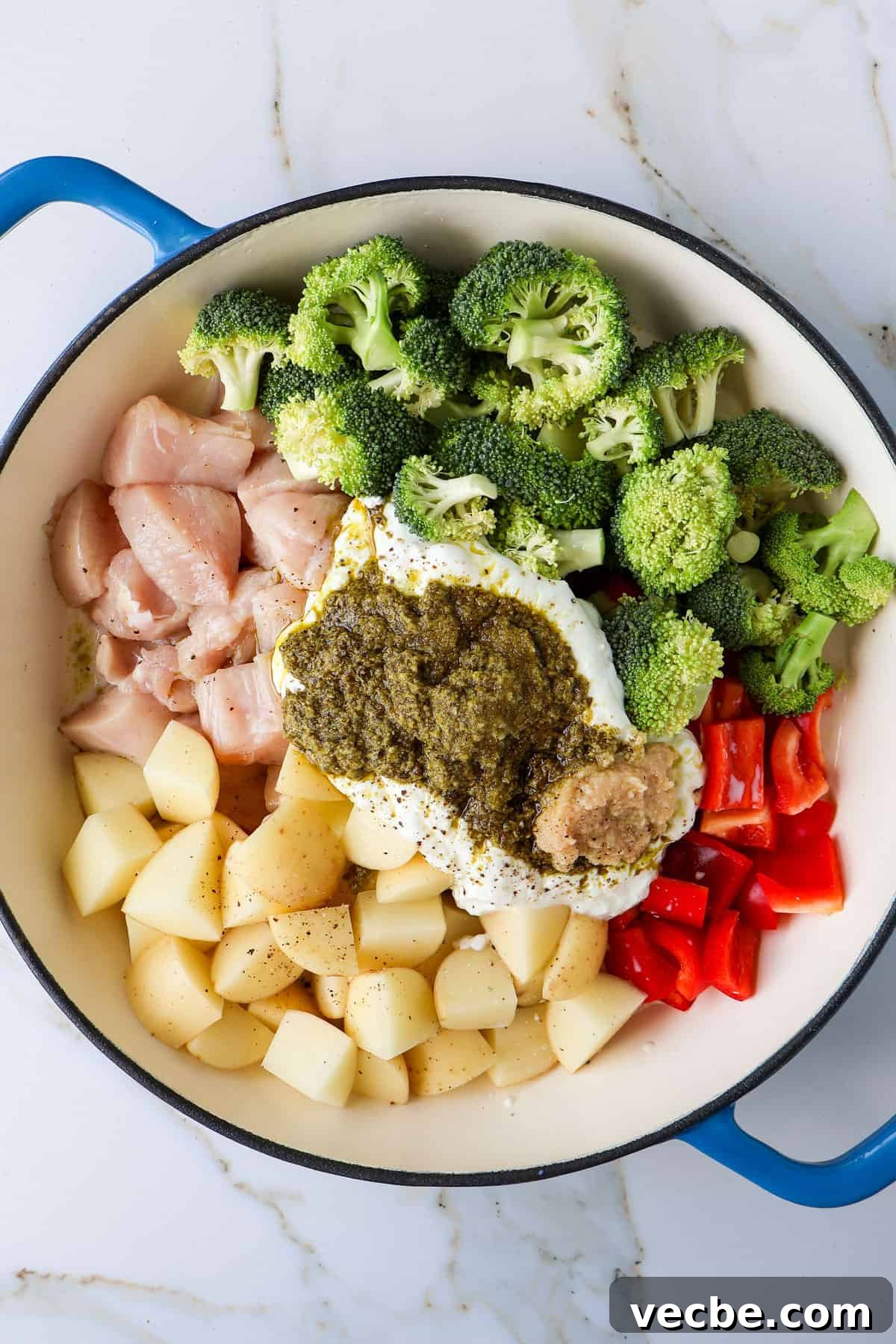 Creamy Baked Chicken, Broccoli and Potato Casserole 5 Ingredients added to a casserole dish before being mixed together.