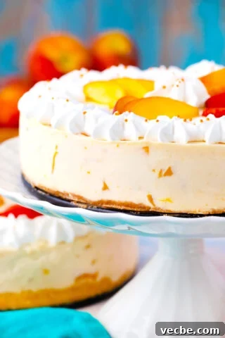 No bake peach cheesecake on a cake stamnd.