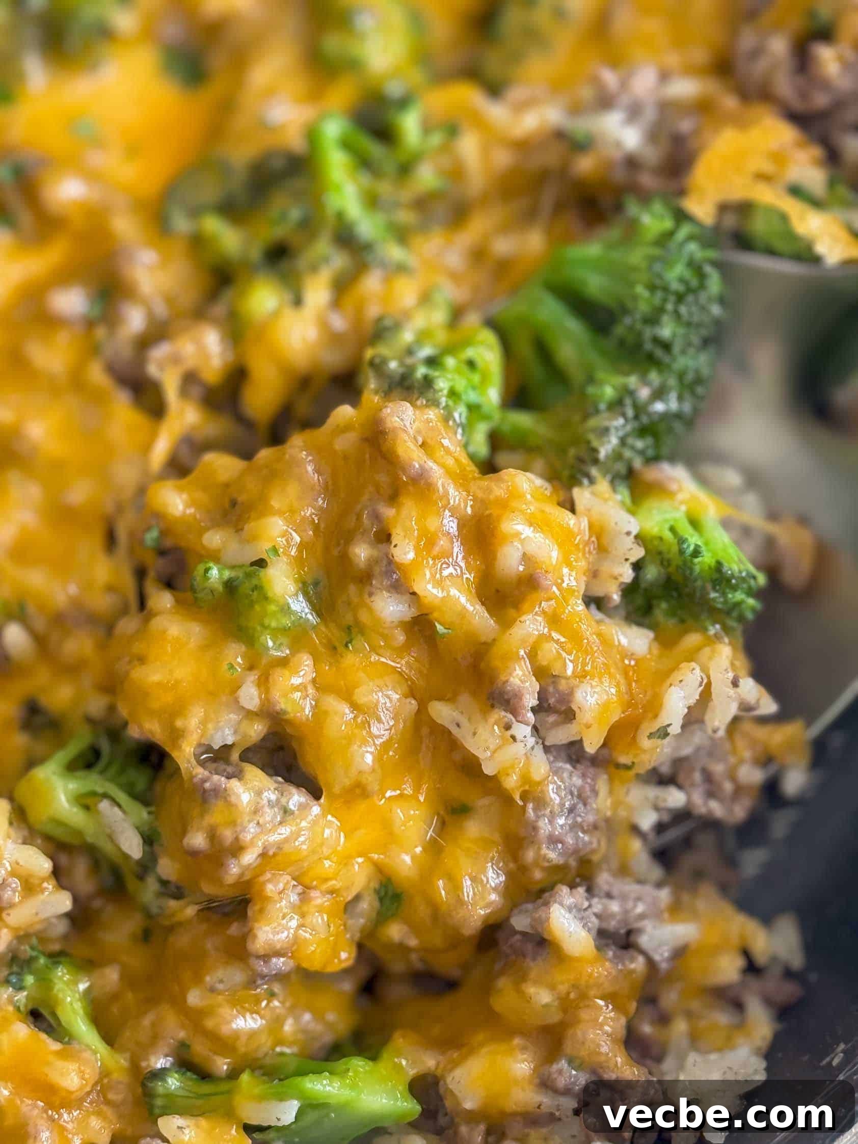 Cheesy Ranch Ground Beef and Rice Skillet 3 Close up view of beef and rice casserole on a spoon.