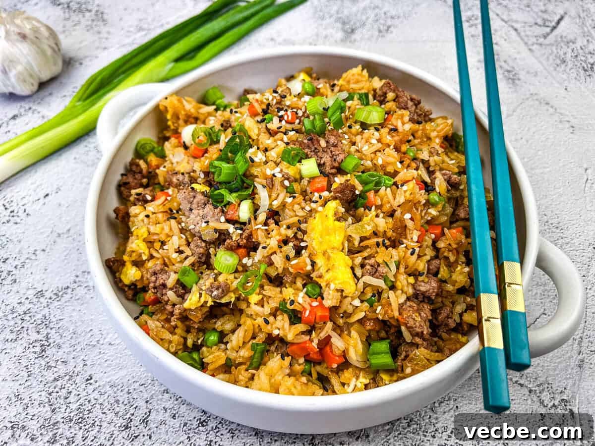 25 Ground Beef Recipes for Real Weeknight Dinners 18 Ground Beef Fried Rice served in a white bowl.
