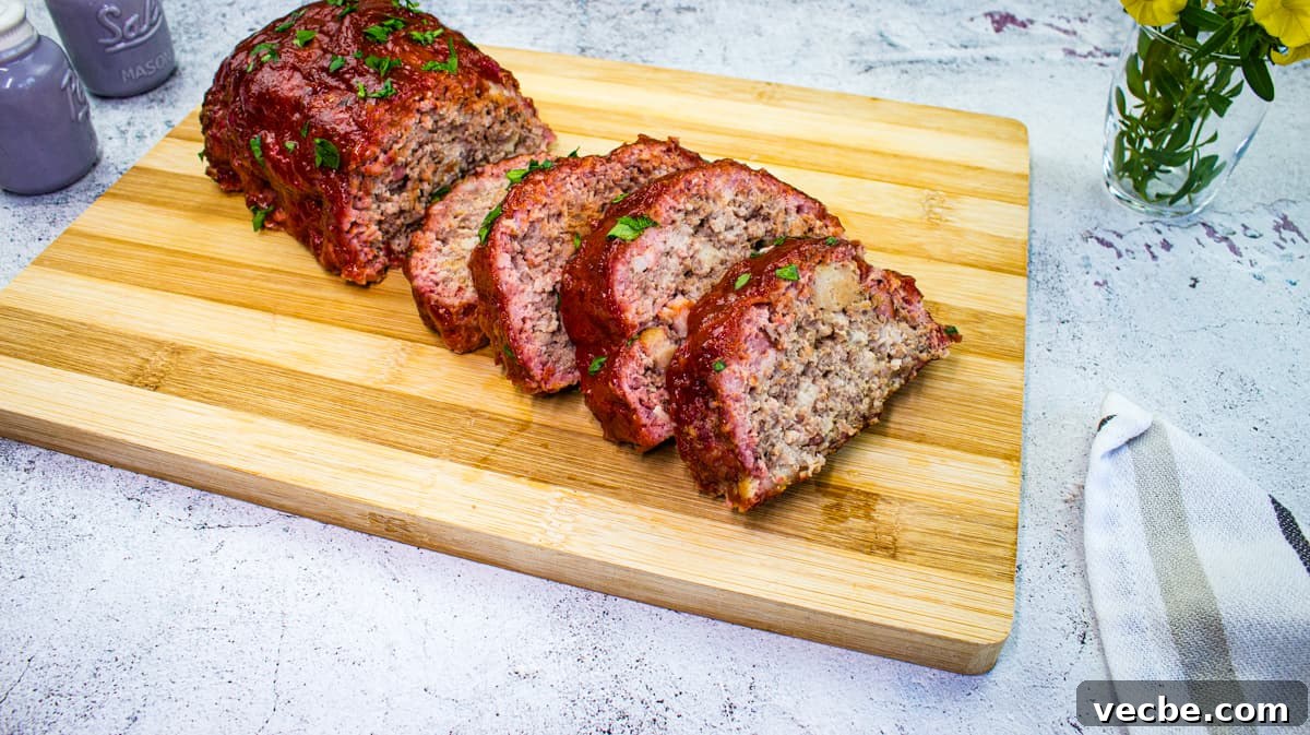 25 Ground Beef Recipes for Real Weeknight Dinners 25 Sliced Smoked Meatloaf on a cutting board with salt and pepper shakers on the side.