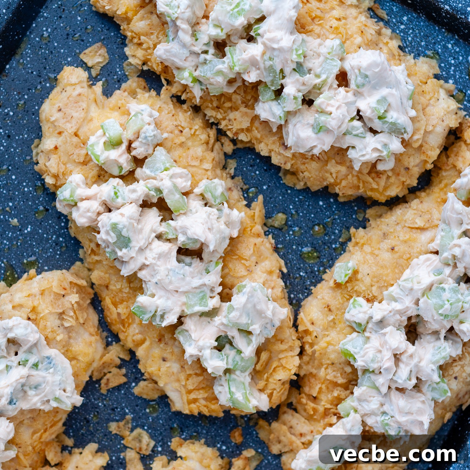Buffalo Chicken Bake with Tortilla Chip Crust 7 cream cheese buffalo topping on baked chicken.