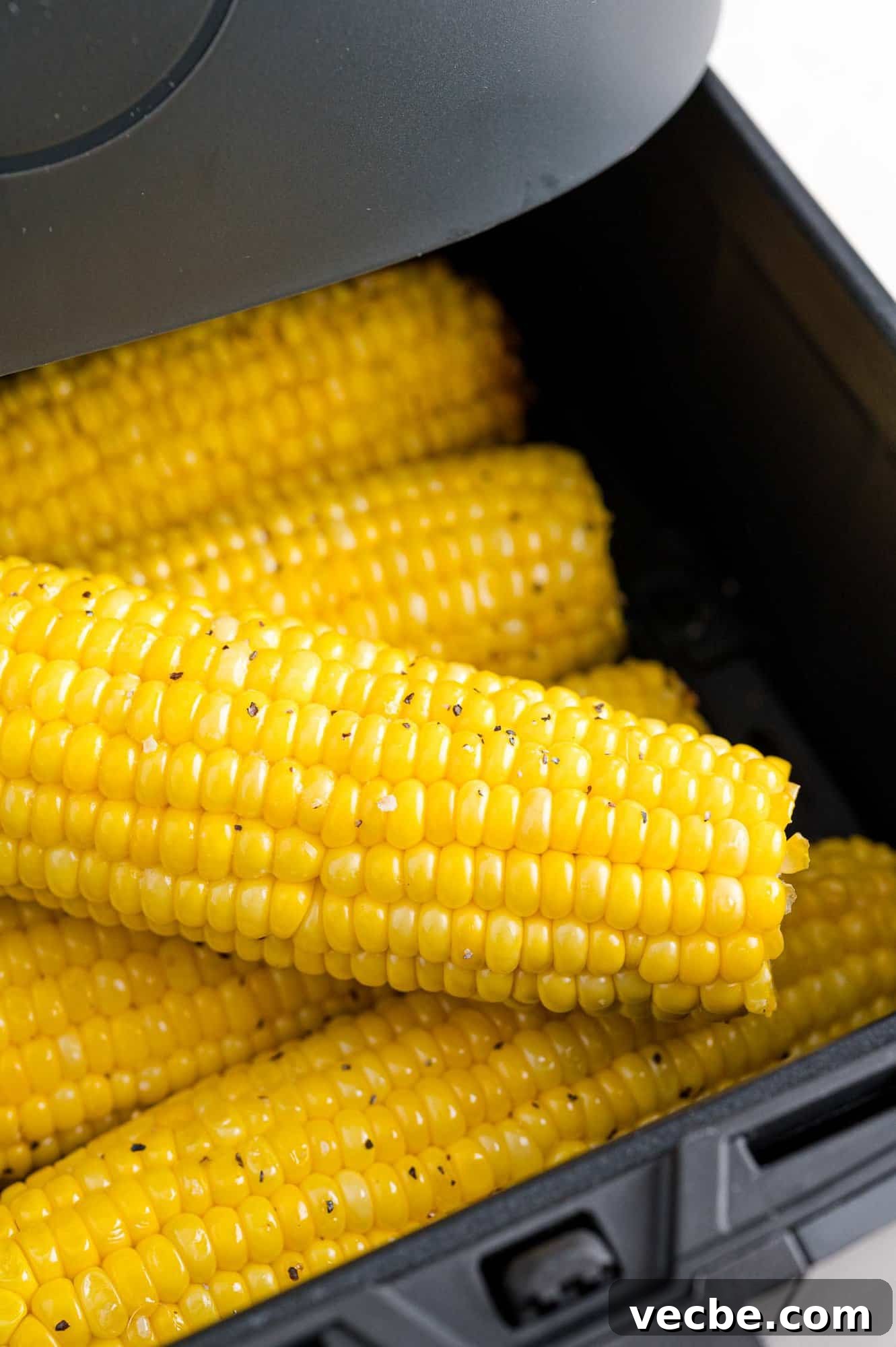 Crispy Buttered Air Fryer Corn on the Cob 9 Air fryer corn on the cob inside the open air fryer basket.