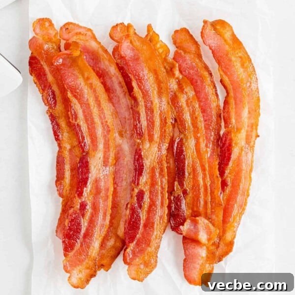 Crispy Buttered Air Fryer Corn on the Cob 11 Crispy air fryer bacon on a white background.