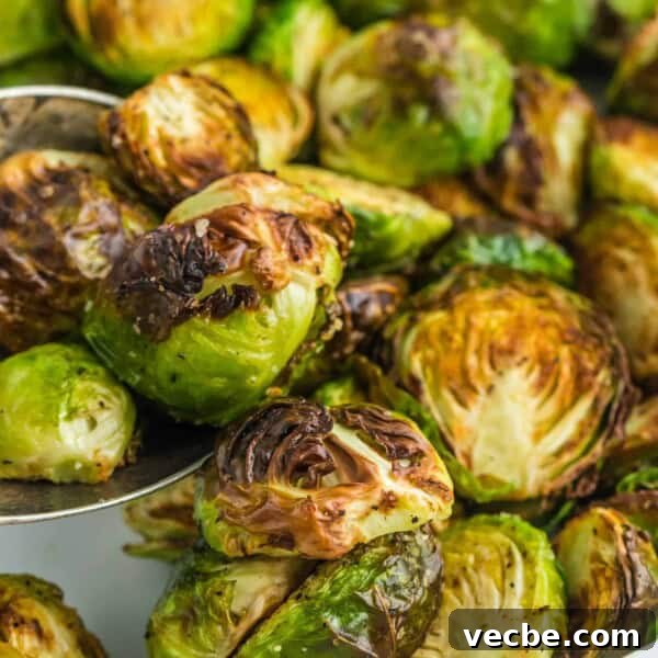 Crispy Buttered Air Fryer Corn on the Cob 13 Close up of perfectly done air fryer brussels sprouts cut in half.