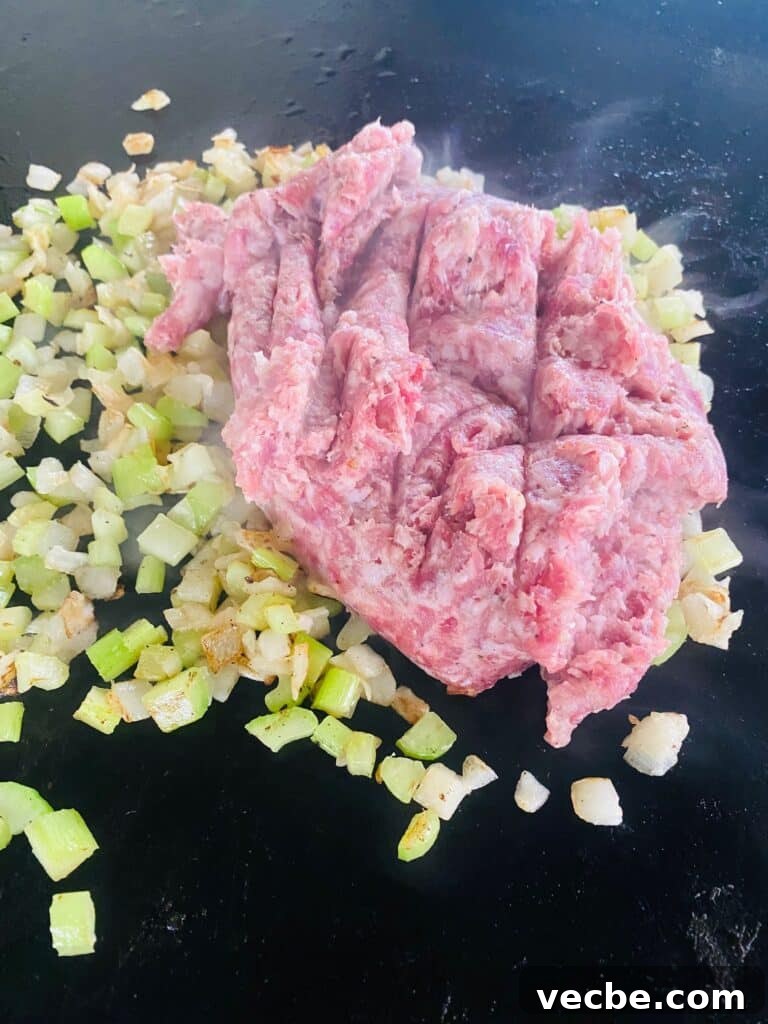Crispy Sausage and Cranberry Stuffing on a Blackstone Griddle 6 adding sausage