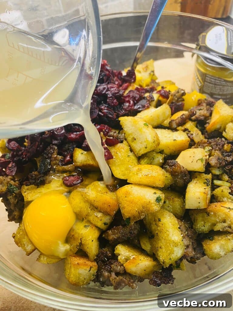 Crispy Sausage and Cranberry Stuffing on a Blackstone Griddle 10 adding chicken broth