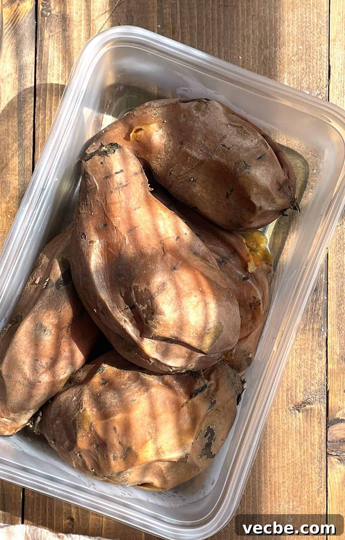 How to Cook Sweet Potatoes in the Instant Pot 8 Cooked sweet potatoes in their skins in a tupperware.