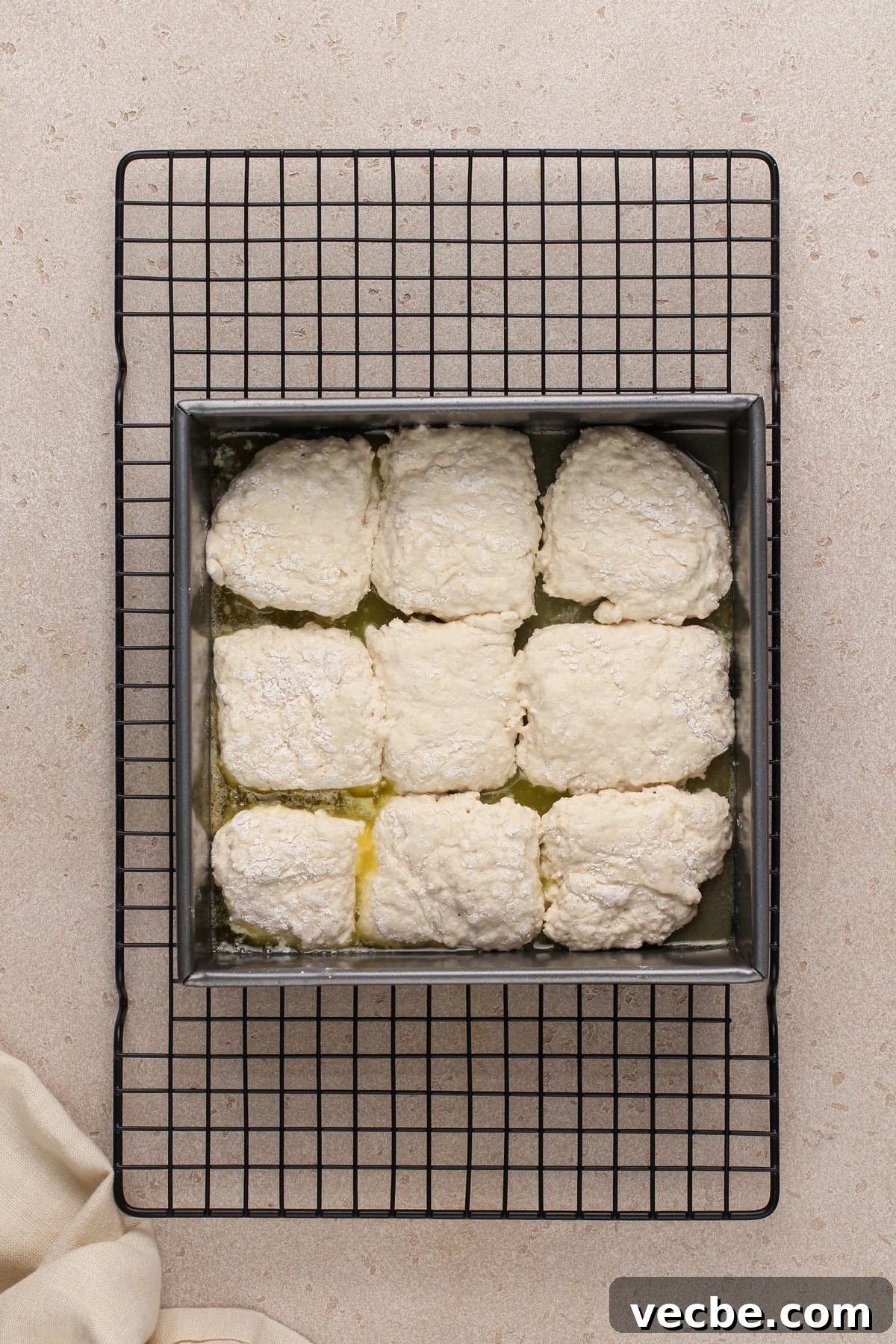Fluffy 7-Up Biscuits Recipe 7 Unbaked 7up biscuits in a metal pan, ready to go in the oven.