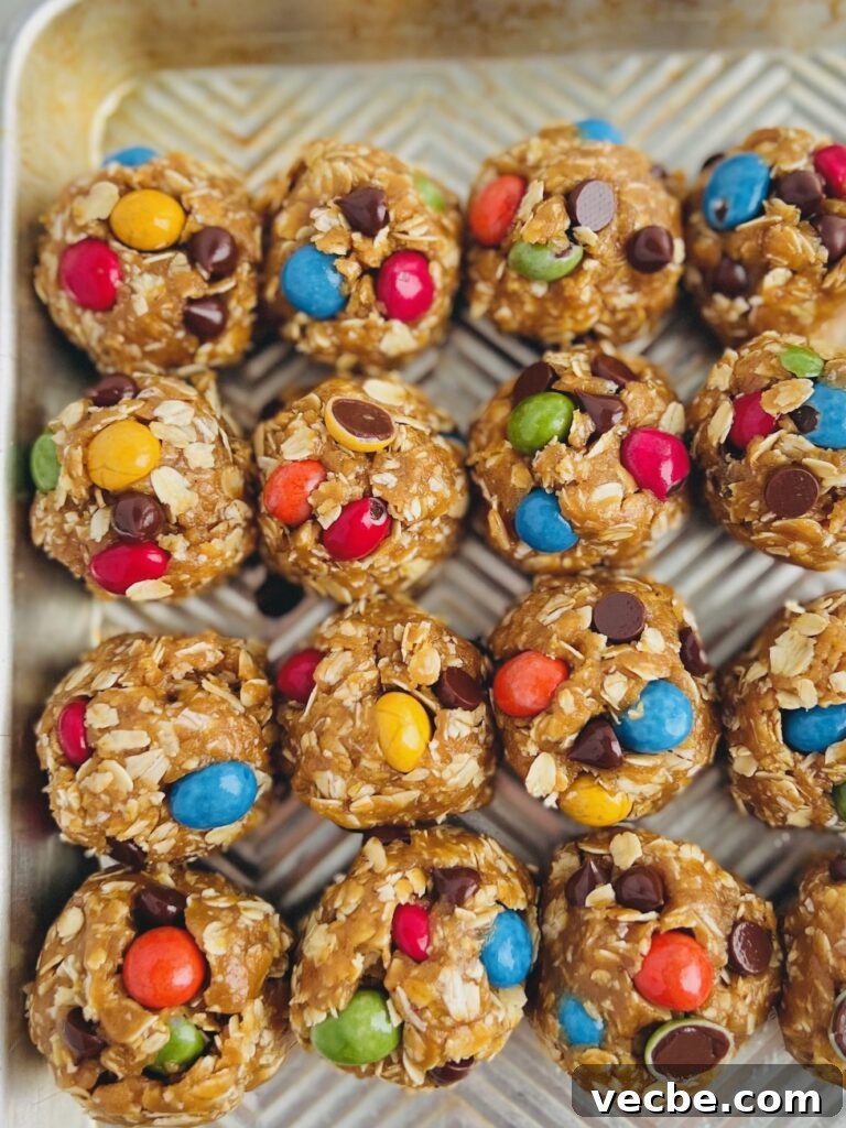 Chewy Monster Cookies with Chocolate Chips and Peanut Butter 5 A cookie sheet with with round balls of cookie dough