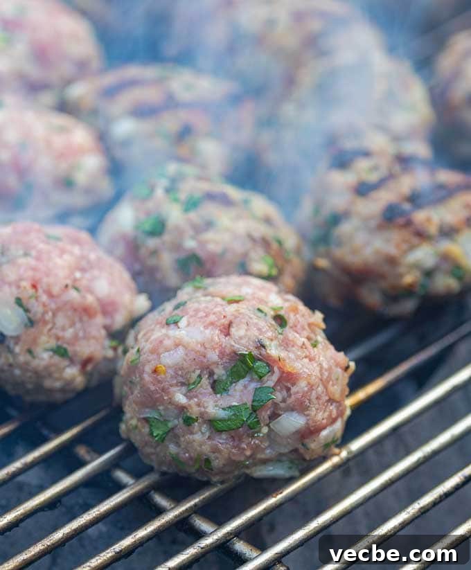 Grilled Italian Meatballs Recipe 6 raw meatballs just placed on the grill